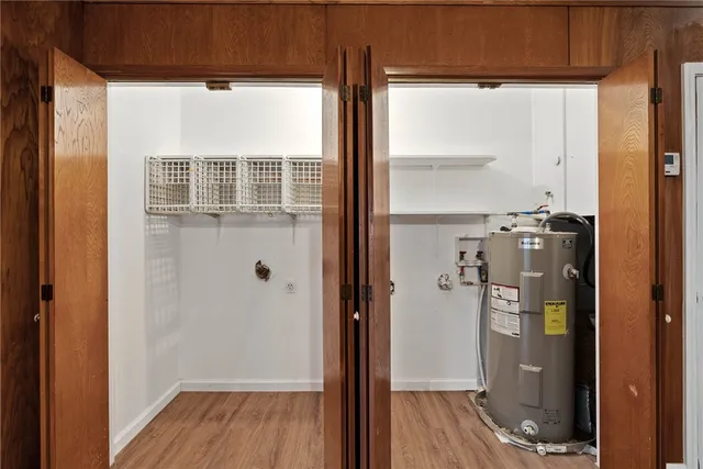 a view of a hallway with wooden floor and entryway