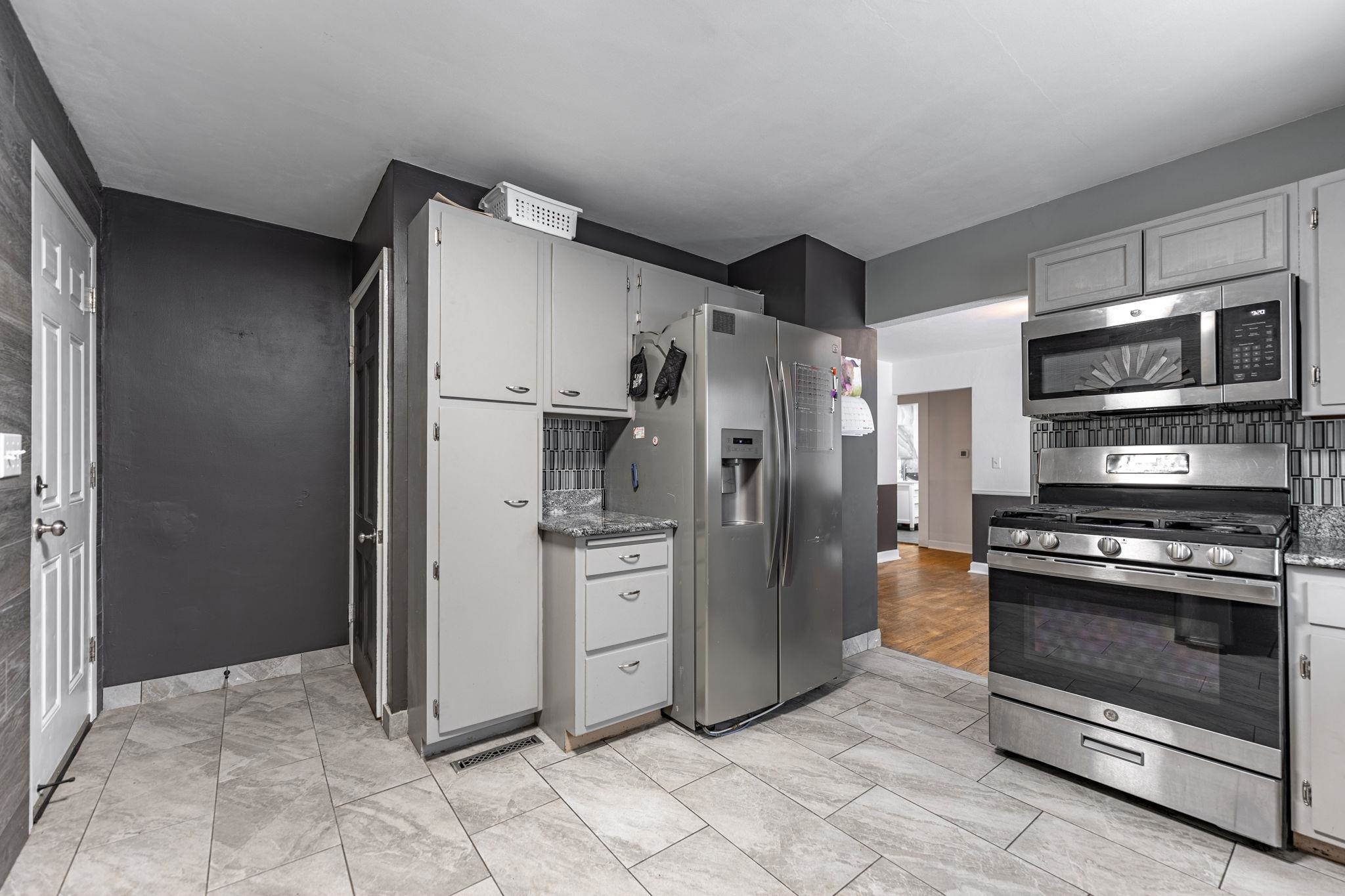 1924 North Alpine Road Rockford, IL 61107 - Photo 11 of 20 a kitchen with stainless steel appliances granite countertop a refrigerator and a stove top oven