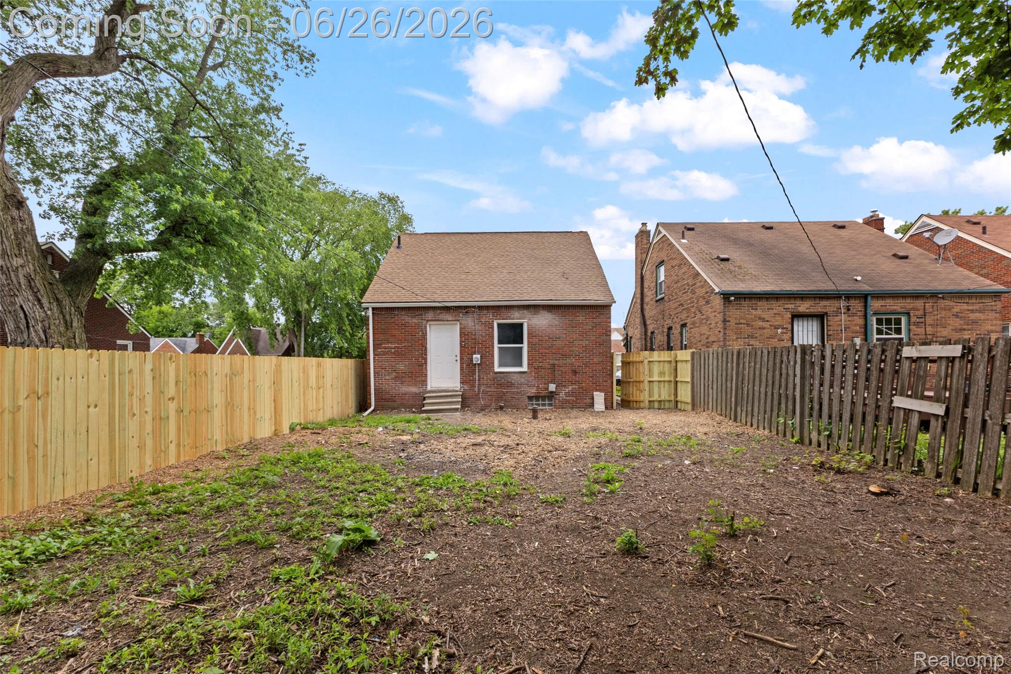 8310 Whitcomb Detroit, MI 48228 - Photo 7 of 26 Brick exterior featuring a gabled roof and white rear entry door