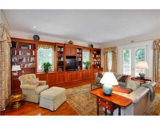 30 Goodwives River Road Darien, CT 06820 - Photo 17 of 20 a living room with furniture a flat screen tv and a large window