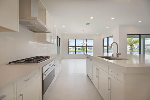 a kitchen with granite countertop a stove and a sink