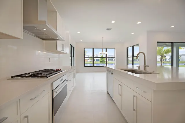 a kitchen with granite countertop a stove and a sink