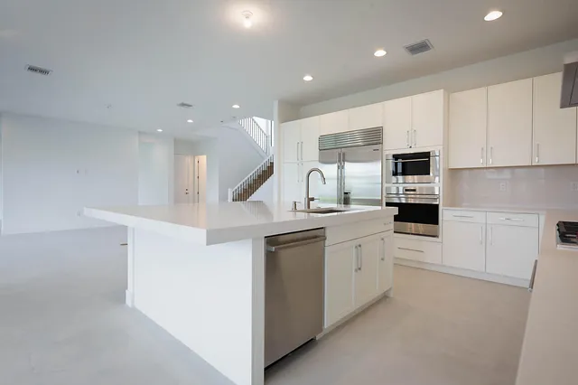 a kitchen with white cabinets and white appliances