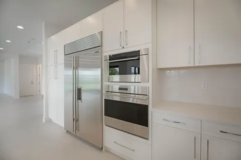 a kitchen with stainless steel appliances cabinets and a counter top space
