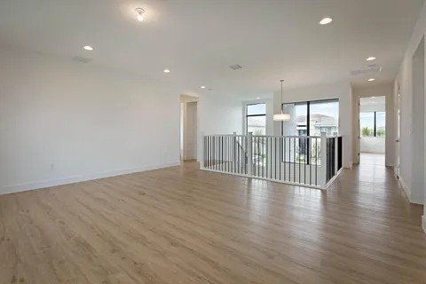 a view of a hallway with wooden floor