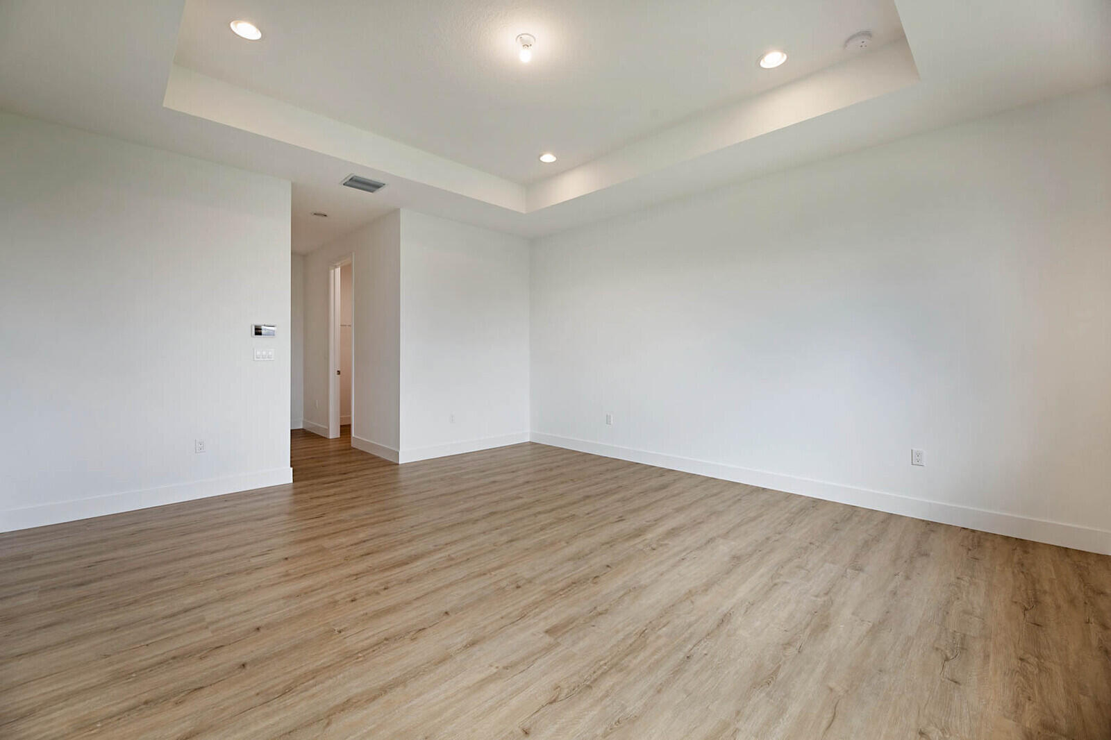 17062 Watersprite Lakes Road Boca Raton, FL 33496 - Photo 23 of 42 a view of an empty room with wooden floor