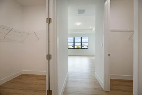 a view of a room with wooden floor and window