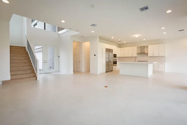 a view of kitchen with kitchen island white cabinets and wooden floor
