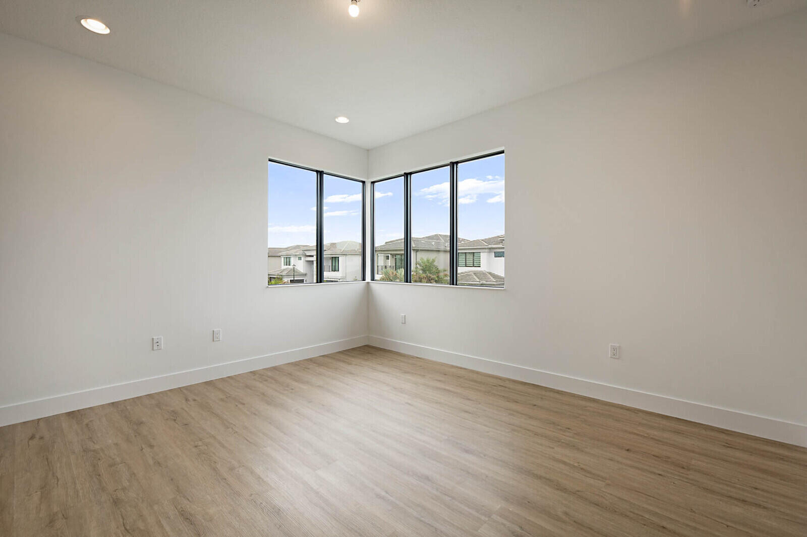 17062 Watersprite Lakes Road Boca Raton, FL 33496 - Photo 34 of 42 an empty room with wooden floor and windows