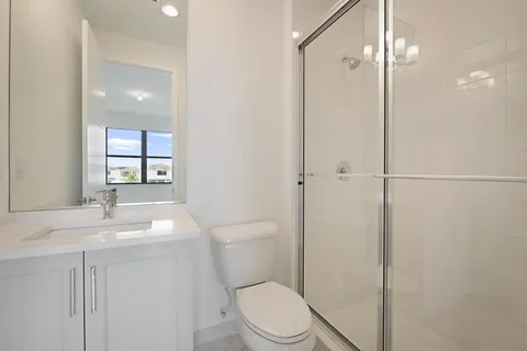 a bathroom with a toilet a sink and shower