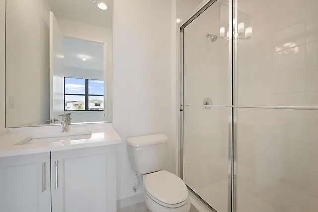 a bathroom with a toilet a sink and shower