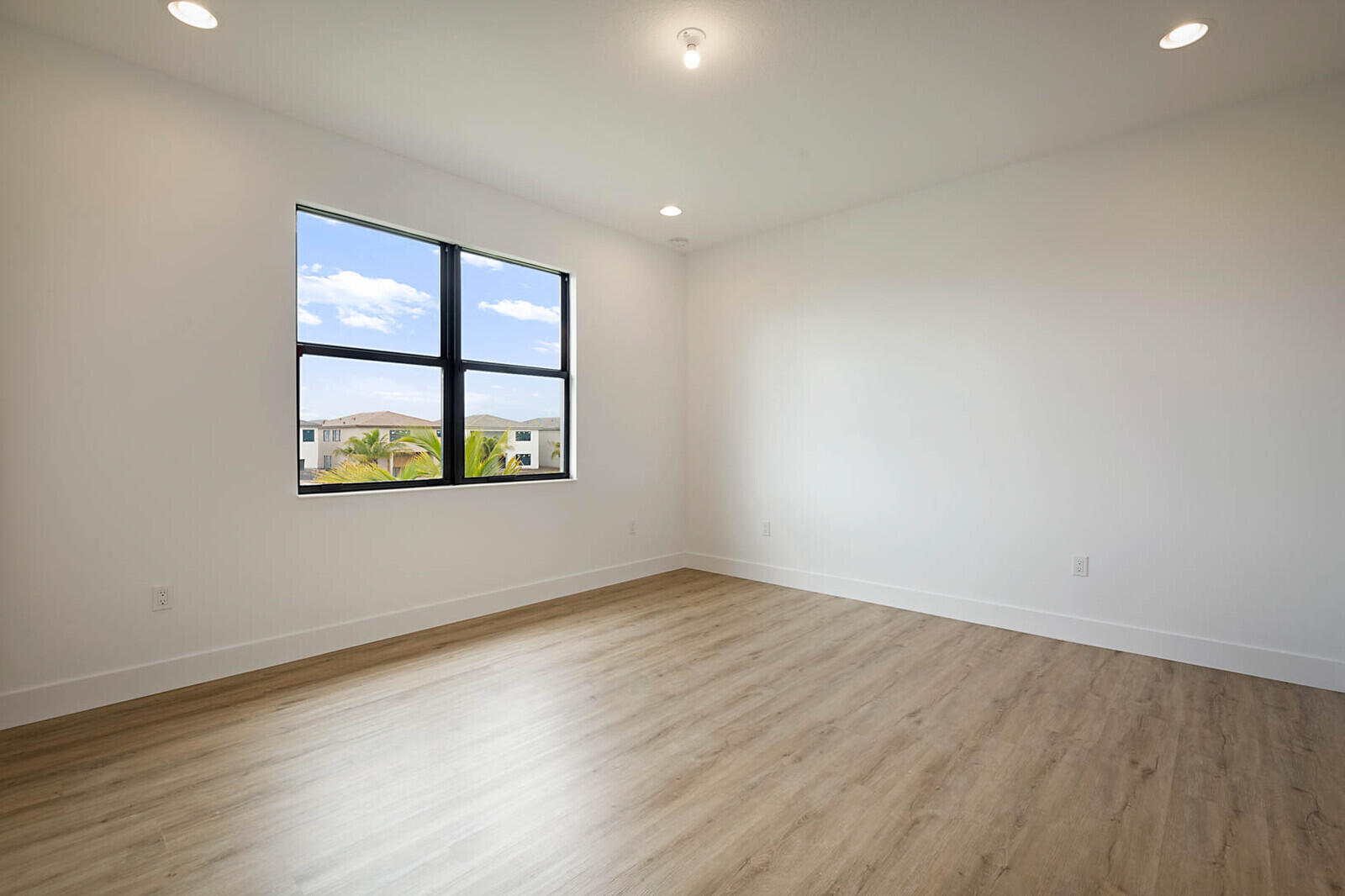 17062 Watersprite Lakes Road Boca Raton, FL 33496 - Photo 36 of 42 an empty room with wooden floor and windows