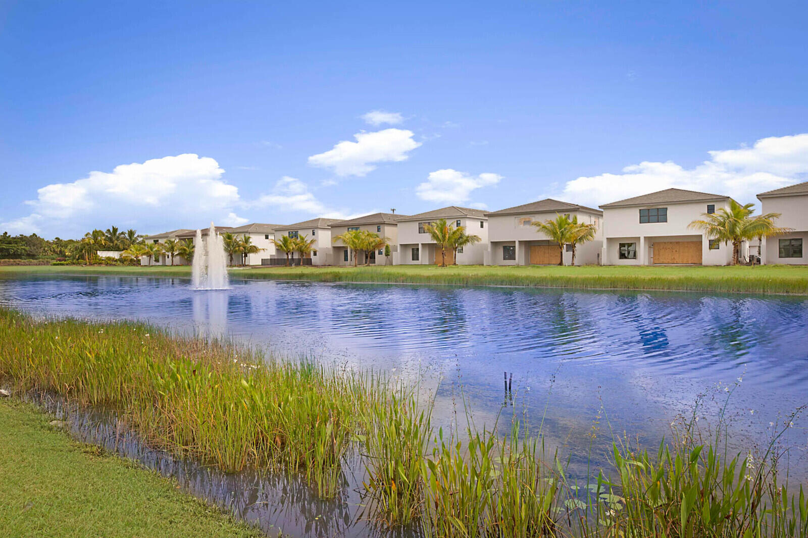 17062 Watersprite Lakes Road Boca Raton, FL 33496 - Photo 42 of 42 a view of a lake with a house in the background