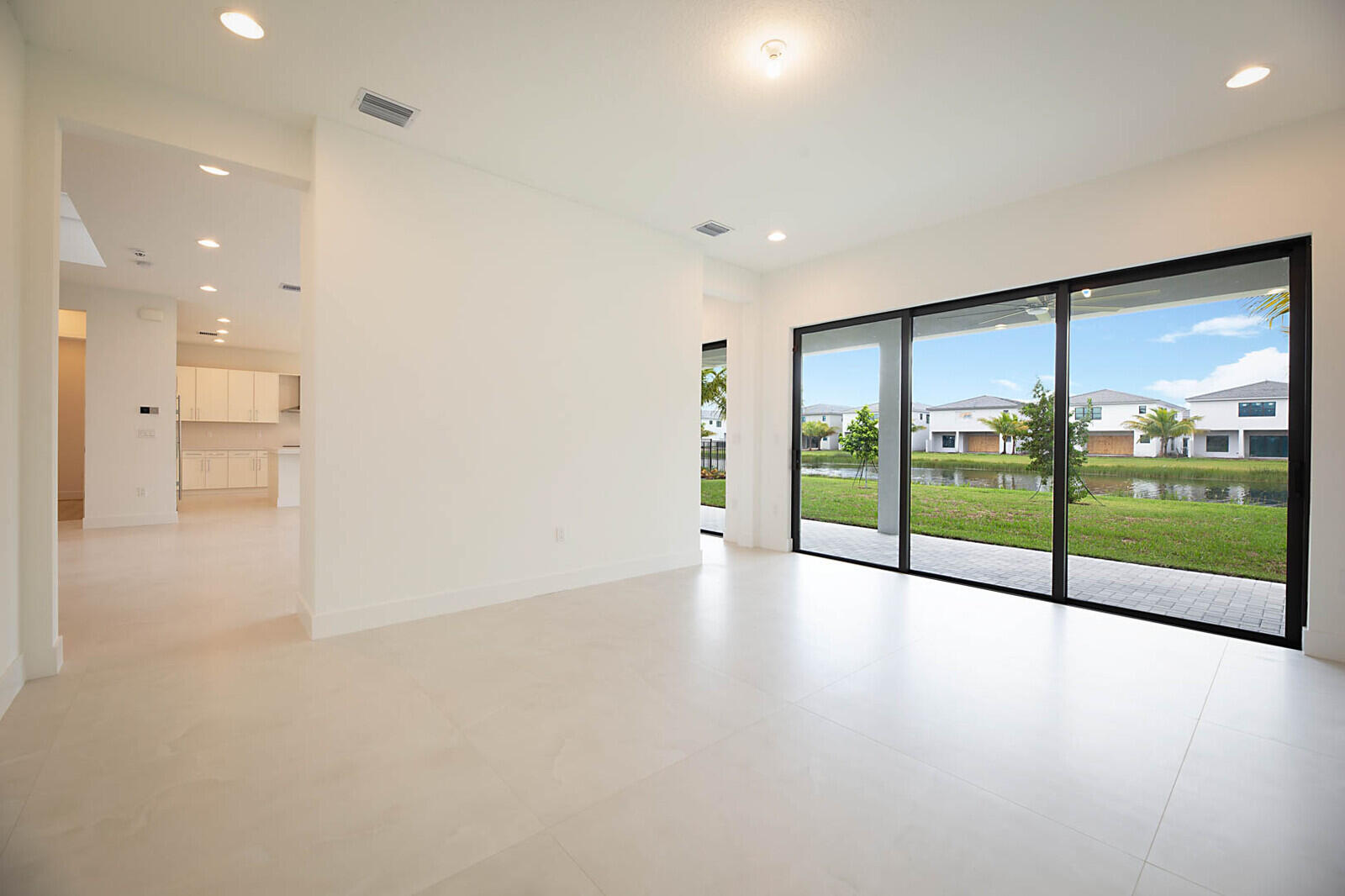 17062 Watersprite Lakes Road Boca Raton, FL 33496 - Photo 5 of 42 a view of an empty room with glass door and windows