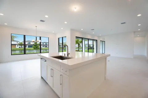 a kitchen with counter top space and windows