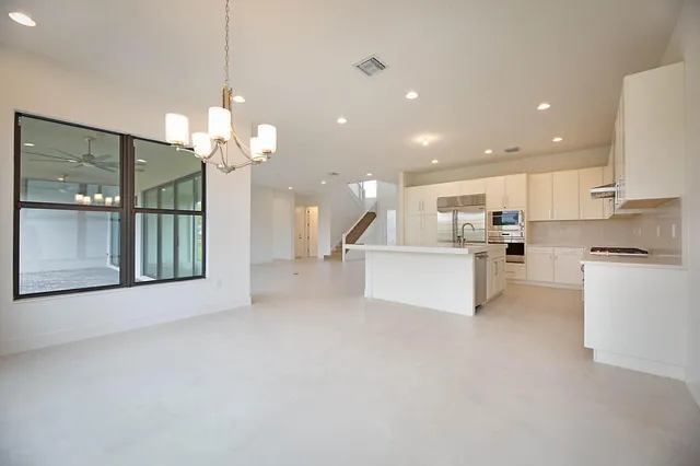 a view of a kitchen with a sink and cabinets