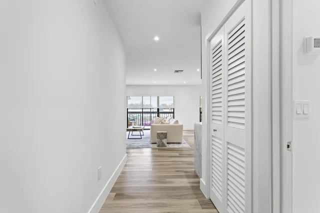 a view of a room with wooden floor