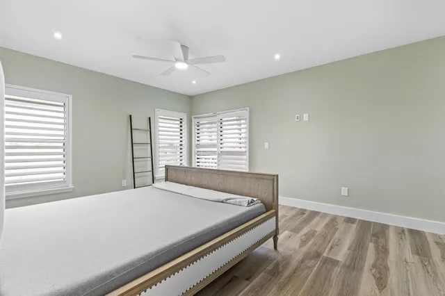 a bedroom with a large bed and a large window