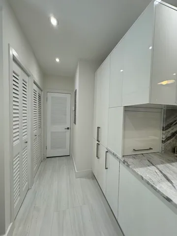 a large kitchen with stainless steel appliances kitchen island granite countertop a stove and a sink with granite countertops