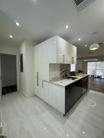 a kitchen with stainless steel appliances granite countertop a refrigerator and a stove top oven