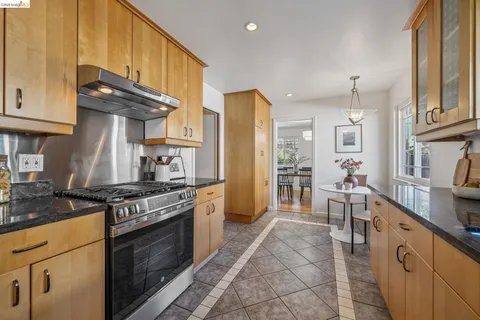 a view of a patio with table and chairs with wooden floor and fence