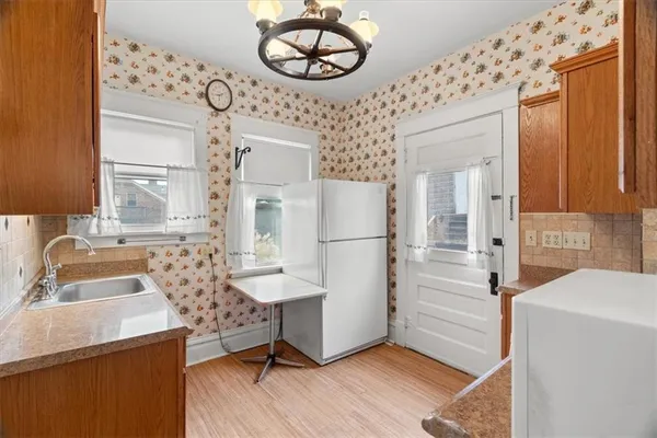 a view of a kitchen area with furniture and wooden floor