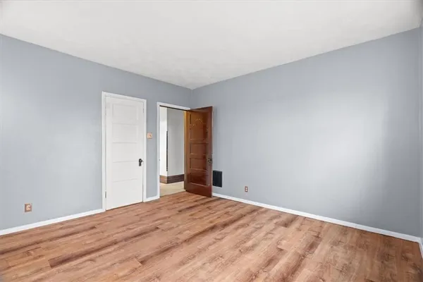 a view of an empty room and wooden floor