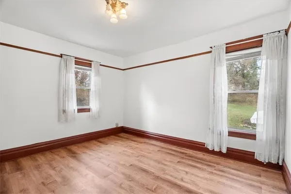 a view of a room with wooden floor and windows