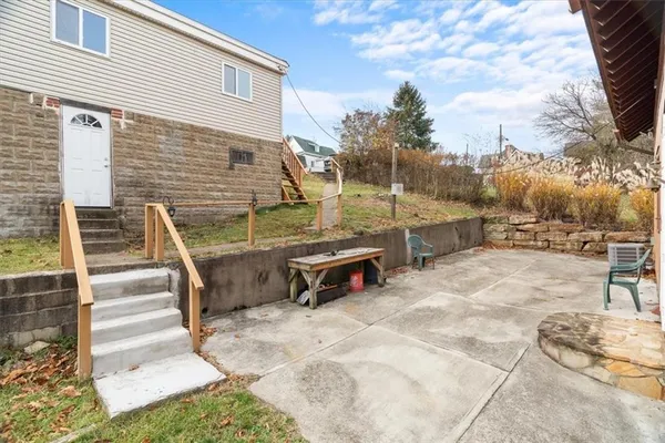 a backyard of a house with outdoor seating