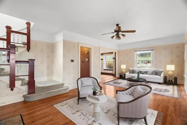 a living room with furniture a couch and wooden floor