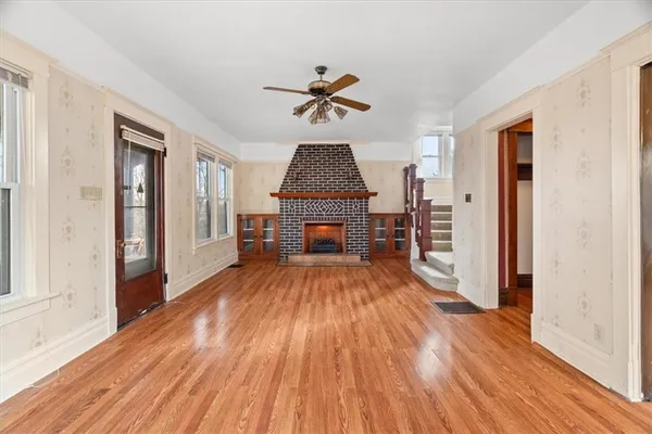 wooden floor in an empty room with a window