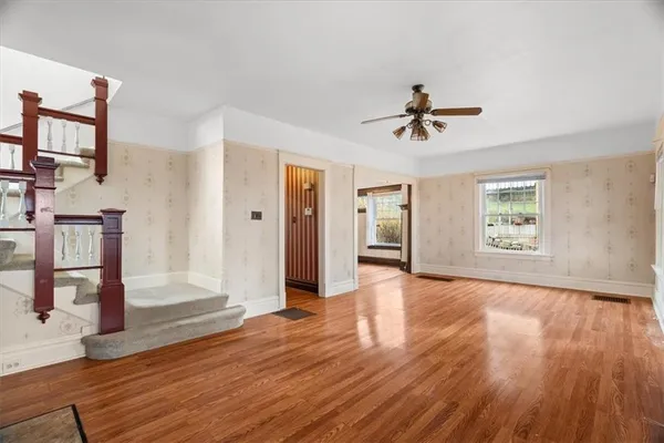wooden floor in an empty room with a window