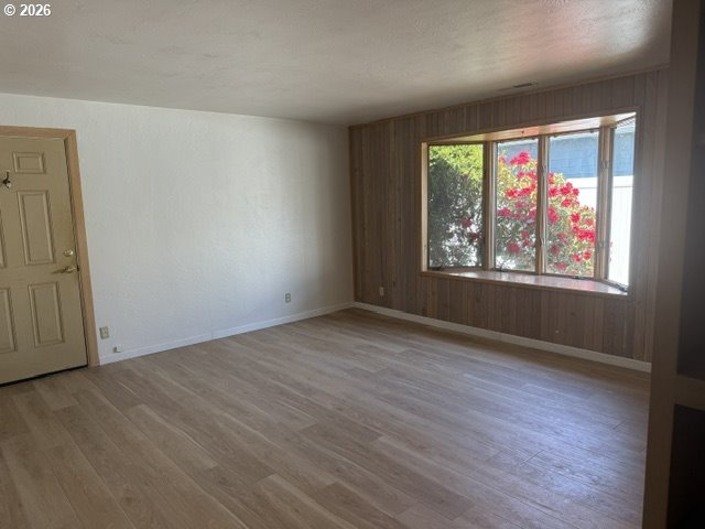 2164 24th Street Florence, OR 97439 - Photo 21 of 42 an empty room with wooden floor and windows