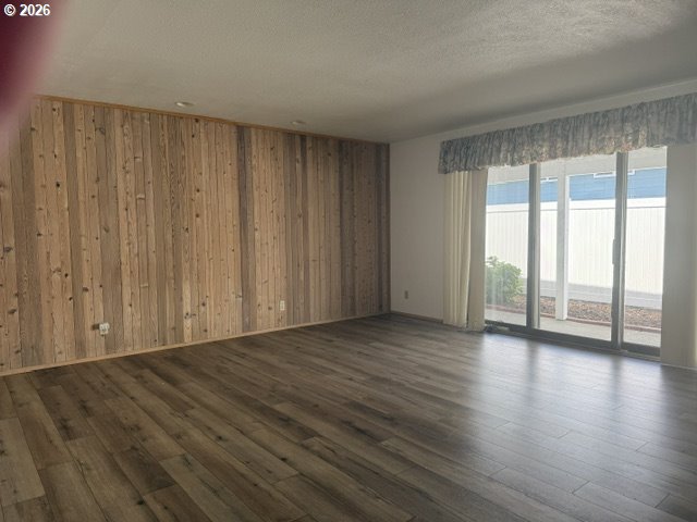 2164 24th Street Florence, OR 97439 - Photo 23 of 42 a view of an empty room with wooden floor and a window