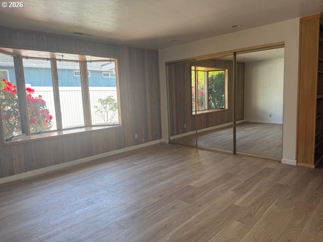 2164 24th Street Florence, OR 97439 - Photo 32 of 42 an empty room with wooden floor and windows