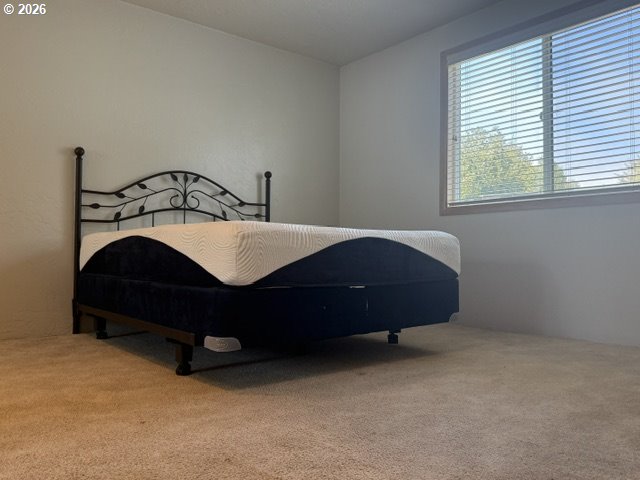 2164 24th Street Florence, OR 97439 - Photo 35 of 42 a bed sitting in a bedroom next to a window