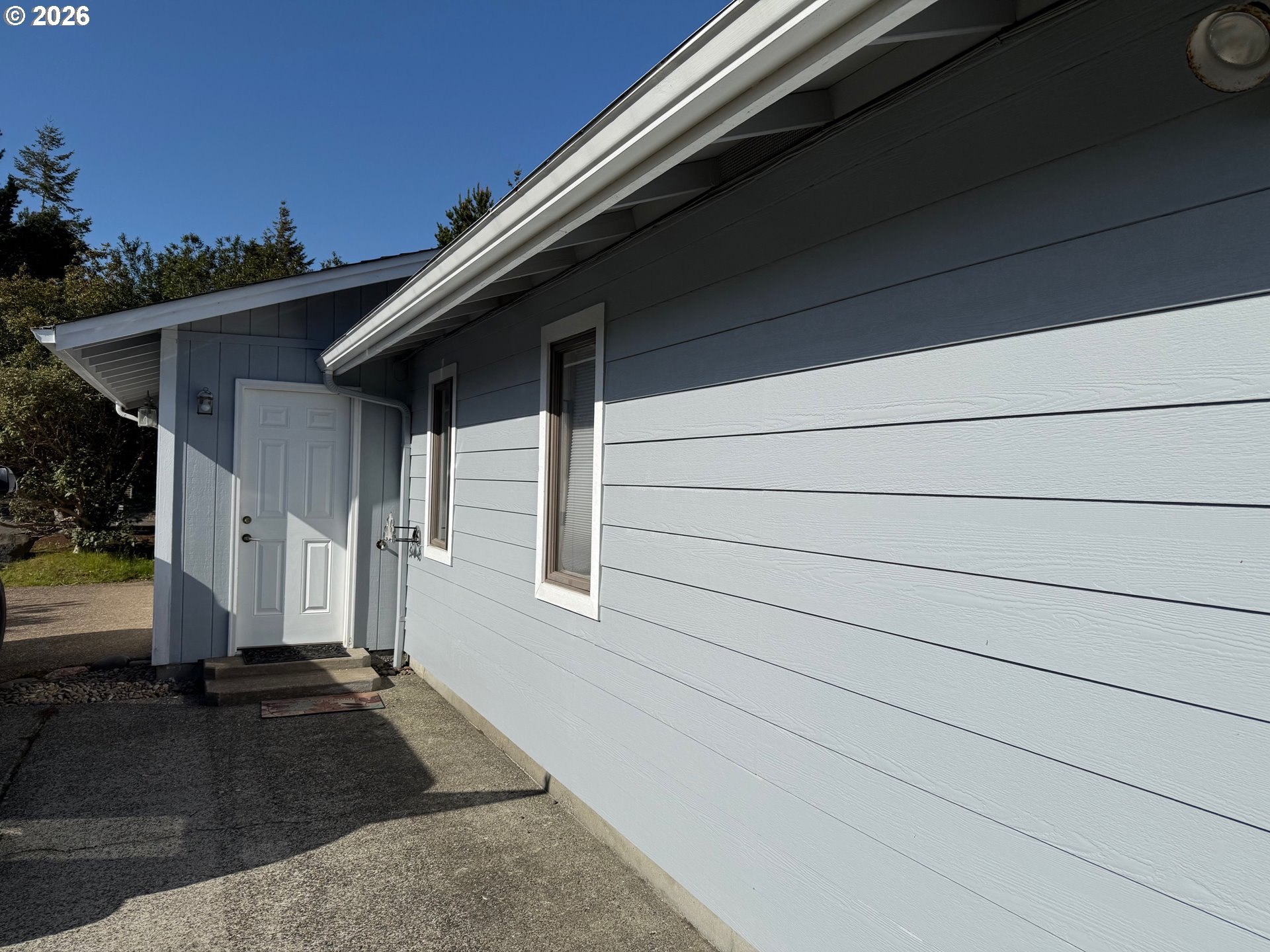 2164 24th Street Florence, OR 97439 - Photo 5 of 42 a front view of a house with a yard