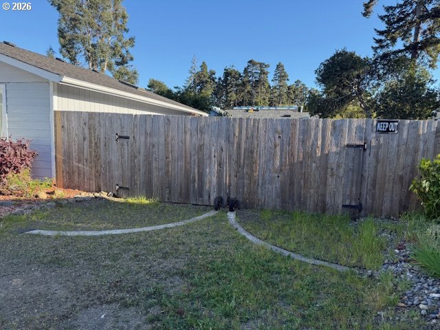2164 24th Street Florence, OR 97439 - Photo 8 of 42 a view of a backyard with wooden fence