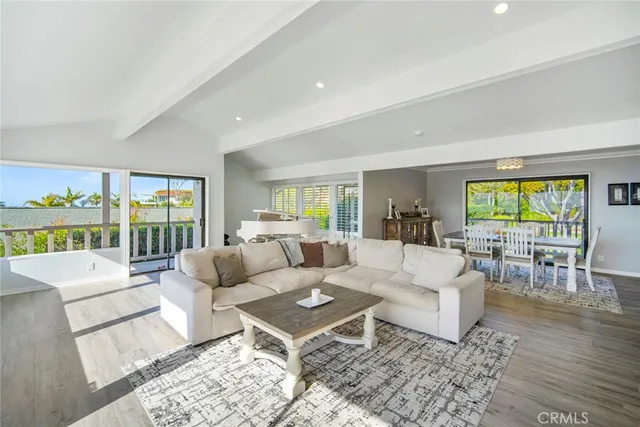 a large kitchen with stainless steel appliances granite countertop a lot of counter space and wooden floors