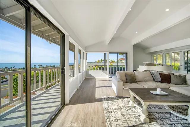 a large white kitchen with wooden floors and white cabinets