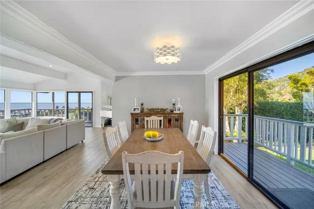 a dining room with furniture and wooden floor
