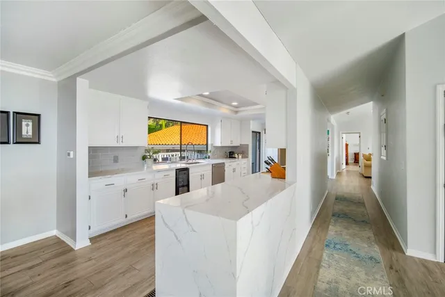 a bedroom with a bed and a flat tv screen on dresser