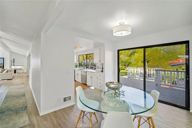 a bathroom with a toilet a sink a mirror a bathtub and window