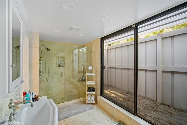a view of a patio with couches table and chairs and potted plants