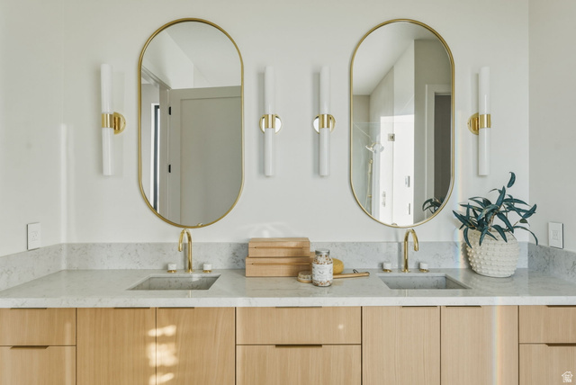 923 North Emery Lane Elk Ridge, UT 84651 - Photo 30 of 101 Dual vanity with light wood-finish cabinetry, integrated sinks, and polished gold-tone fixtures