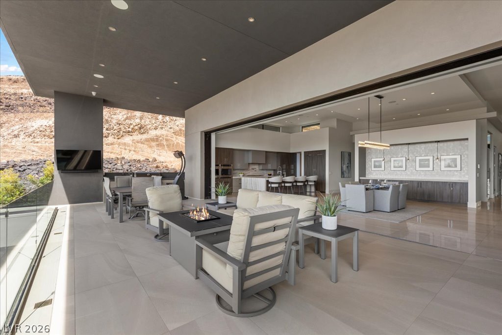 657 Ridgestone Rim Court Henderson, NV 89012 - Photo 48 of 97 Seamless indoor-outdoor integration highlights this modern terrace opening directly into the main living areas.