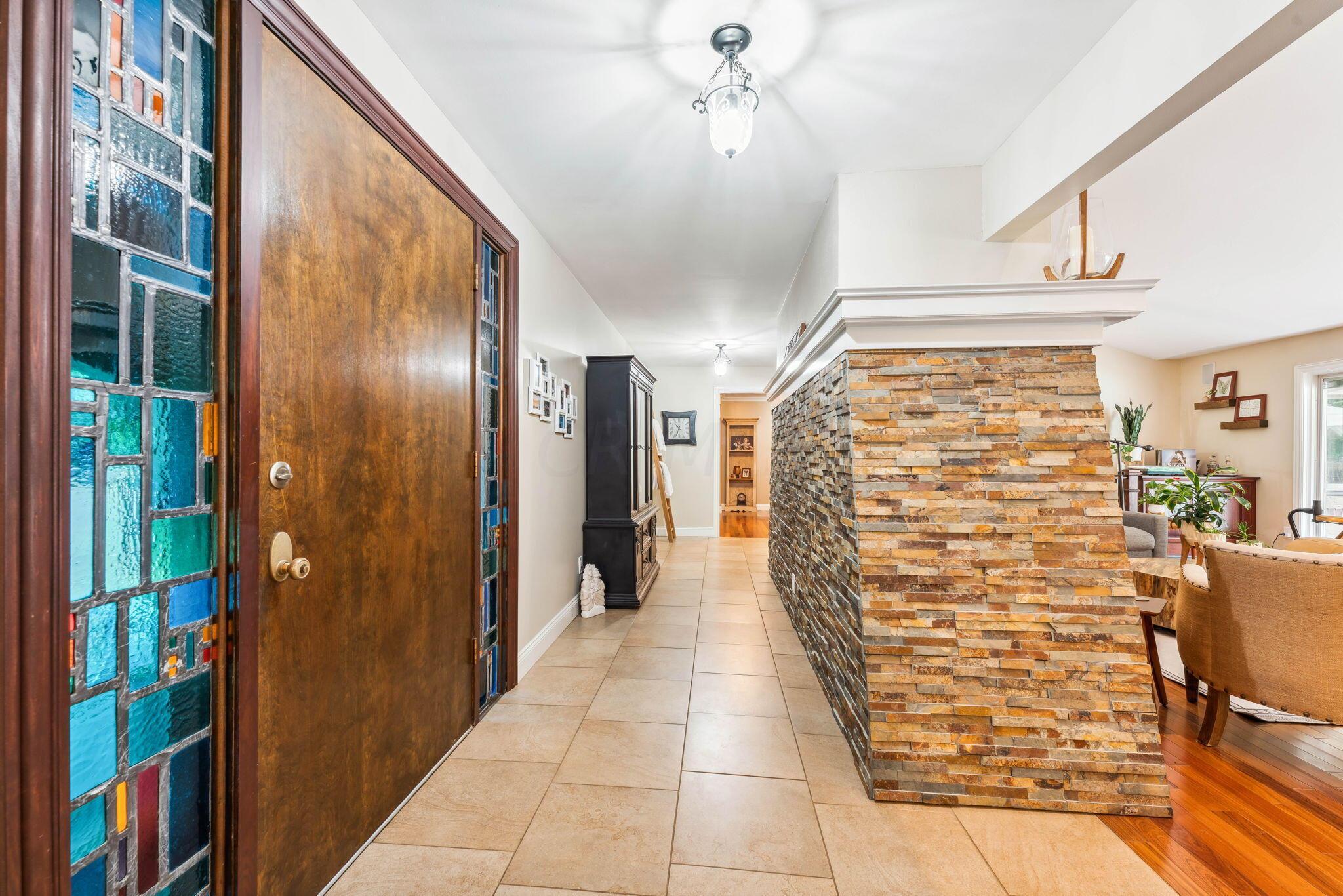 2423 Carriage Road Powell, OH 43065 - Photo 10 of 100 The front door opens directly into the Great Room featuring a wood burning fireplace which heats the entire home throughout the winter!