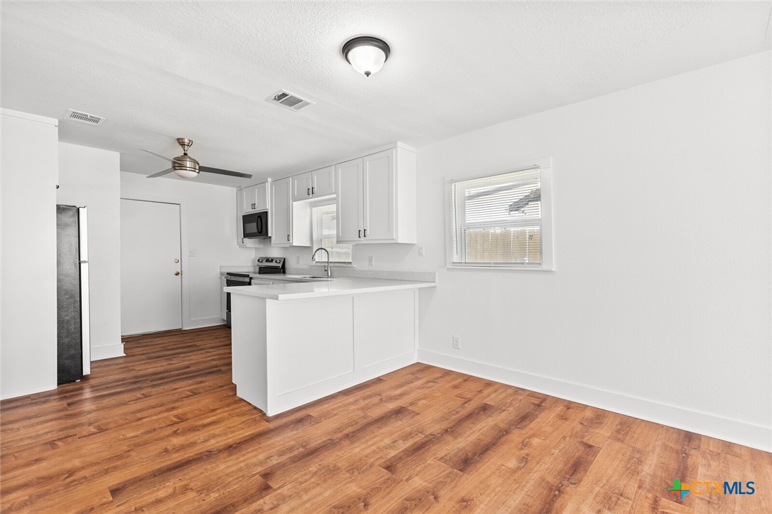 1020 South 23rd Street Temple, TX 76504 - Photo 11 of 38 a view of a kitchen with wooden floor