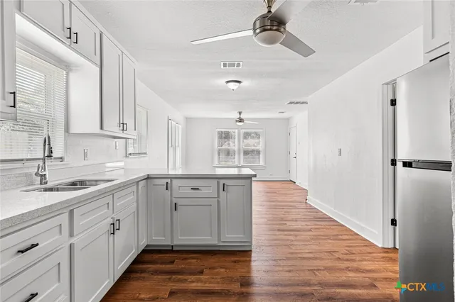 a spacious bathroom with a sink and a mirror