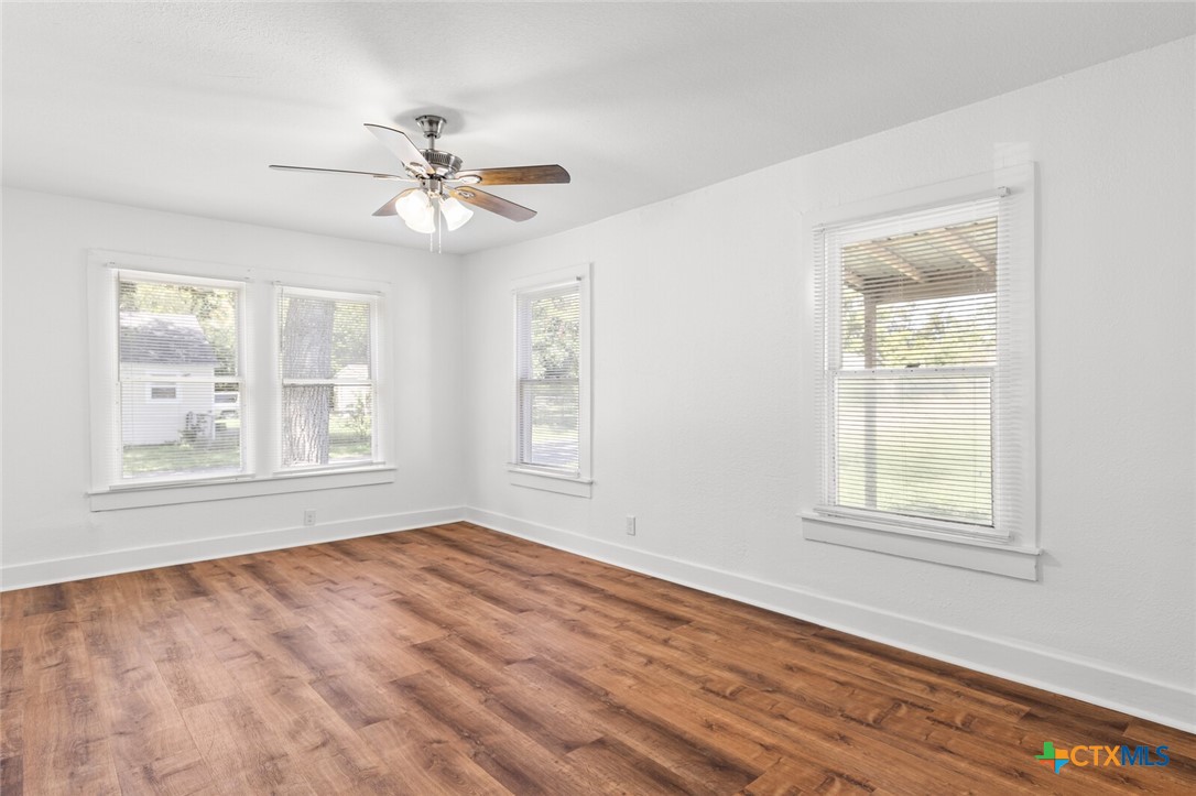 1020 South 23rd Street Temple, TX 76504 - Photo 19 of 38 a view of empty room with wooden floor and fan